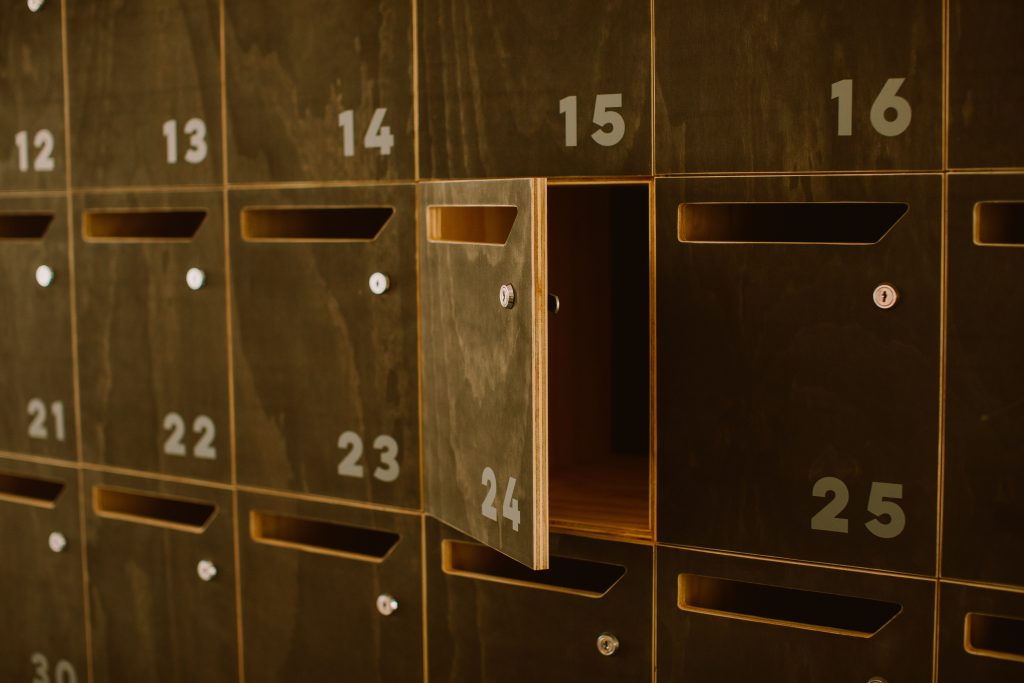 Close up of wooden mailboxes with numbered doors.