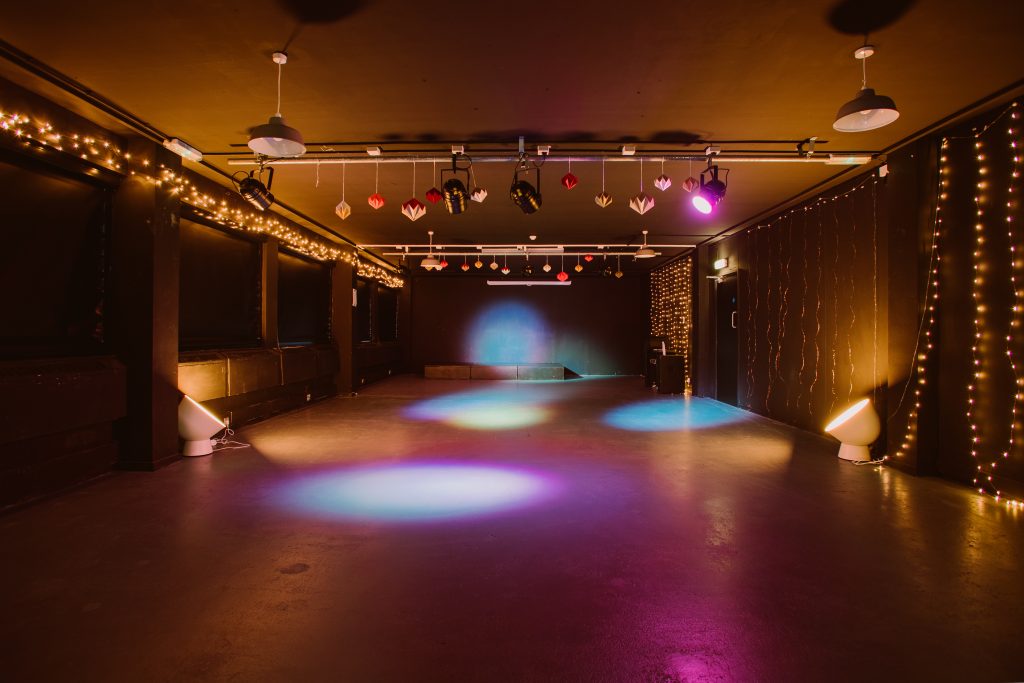 An event space with colourful lights and a stage