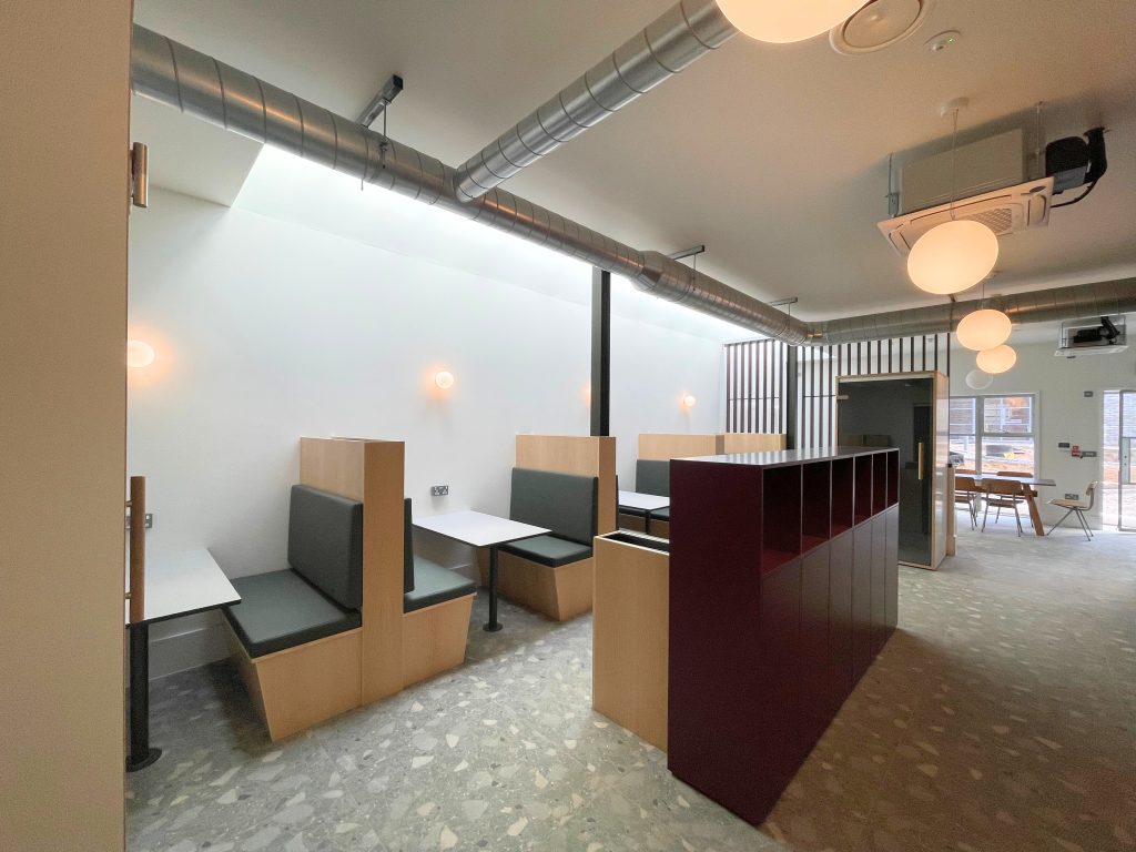 Cafe-style coworking space at Foundry in Camborne, Cornwall. A bright space with booth seating and a terrazzo floor.